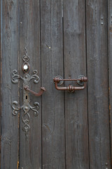 old wooden door with  a wrought iron lock