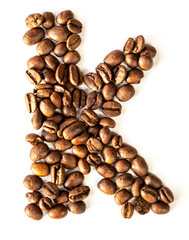 K letter made from coffee beans isolated on white background