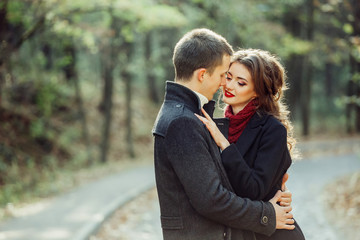 Young happy couple in love hugging outdoors. Tender, romantic, relationships concept