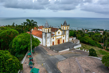 Fototapeta na wymiar The architecture of the historic city of Olinda in Pernambuco, Brazil showcasing the Se Church dated from the 17th century in Baroque style at sunset.