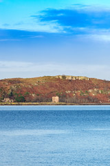 Little Cumbrae from Portencross North Ayrshire on a Cold Day in Scotland and the Ancient Ruins of the Old Castle.