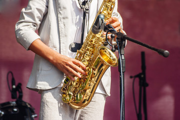 saxophonist playing at a jazz festival in a city park