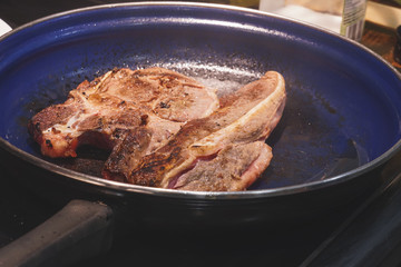 Veil steak being cooked in frying pan/