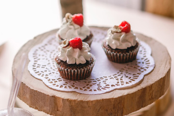 delicious beautiful dessert in cups, delicate cream with raspberries and nuts, ready for distribution