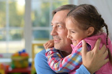 Portrait of a father hugging his daughter