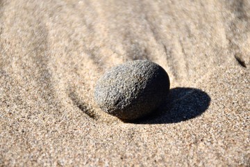 Fototapeta na wymiar Pebble on sandy beach