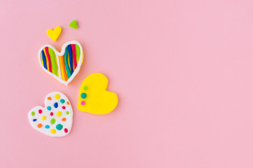 Plasticine hearts on pink background with copy space
