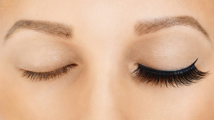 Female eyes with long false eyelashes, befor and after effect. Eyelash extensions, make-up, cosmetics, beauty