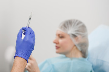 girl do plastic operation in medical clinic; doctor does lip augmentation surgery; injecting...