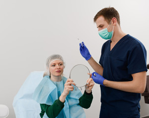 girl do plastic operation in medical clinic; doctor does lip augmentation surgery; injecting...