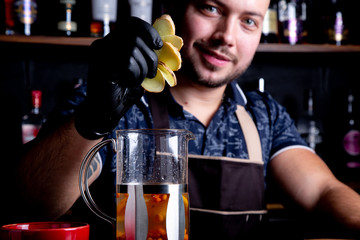 Process brewing tea,tea ceremony. Bartender adds sliced ginger into the kettle for brewing sea Fruit tea