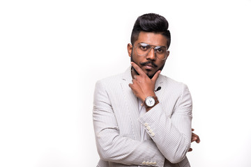 Portrait of thinking stylish hipster indian young man touch his beard isolated on white background