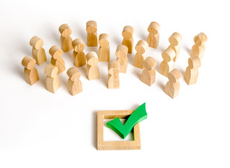 A crowd of people looks at a green check mark. Voting and election concept. Referendum, revolution....