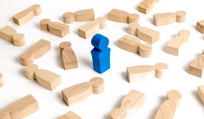 blue man stands among the many lying figures of people. The concept of selectivity. Leader, leadership, head of organization. Organization of business processes, team building. example to follow