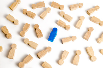 blue man among the many lying figures of people. The concept of selectivity. Leader, leadership, head of organization. Organization of business processes, team building. example to follow
