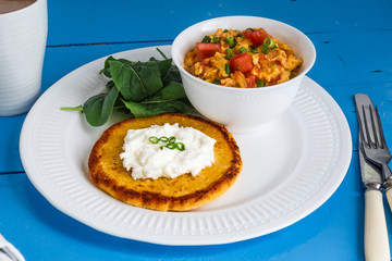 Traditional colombian breakfast huevos pericos with corn cakes