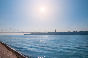 Fototapeta na wymiar Lisbon Bridge of 25th april in Portugal. River Tejo in sunny day in Lisboa.