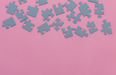Puzzles on a pink background as a symbol of autism. Conceptual vision of the problem of autistic children