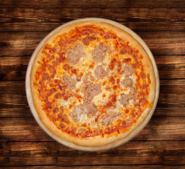 Isolated Tuna Pizza on a wooden background.
