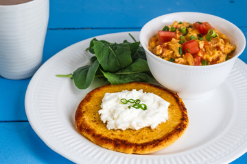Traditional colombian breakfast huevos pericos with corn cakes