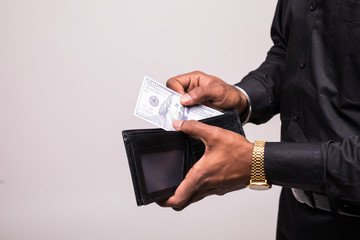 Businessman saving money. Close up man carrying a wallet in hand, the dollar, finance accounting concept