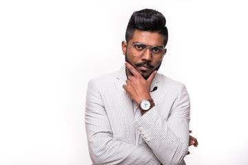 Portrait of thinking stylish hipster indian young man touch his beard isolated on white background