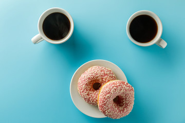 two cups of coffee and donuts. Copy space. Top view