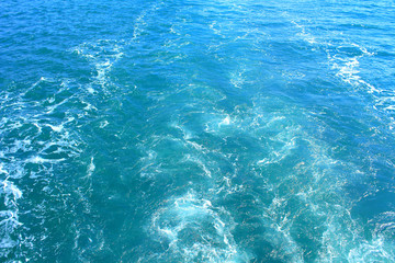 The wake from the boat at sea. Close-up. Background. Texture.