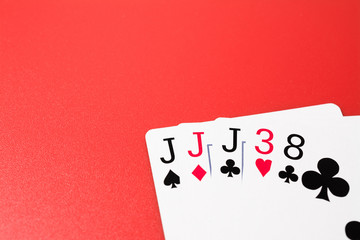 Poker hands playing cards three of a kind on a red background