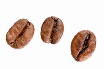Coffee beans. Three roasted coffee bean maccro view, close up, isolated on white background.