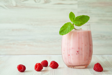 Raspberry milkshake with a mint leaf