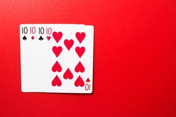 Playing cards four ten on a red background