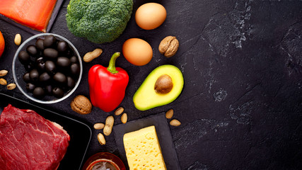 Picture of products for diet on black stone table . Place for inscription on side of photo.