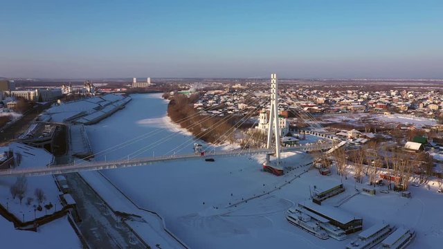 Bridge across the frozen river in Tyumen, Russia