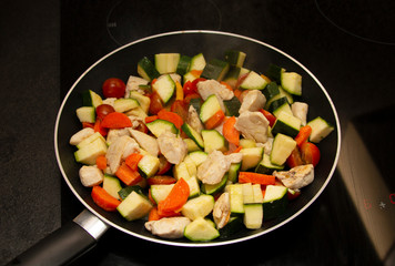 vegetables with meat on a griddle, close-up, healthy food