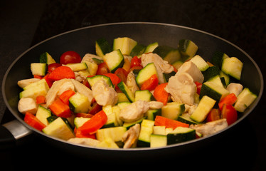 vegetables with meat on a griddle, close-up, healthy food