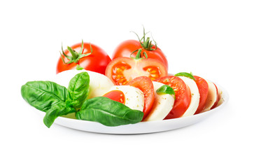  Сaprese salad with ripe tomatoes and mozzarella cheese with fresh basil leaves. Italian food. 