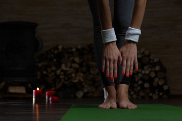 Close up of lady with red nails trying to touch the toes