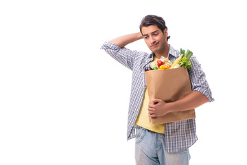 Young man with his grocery shopping on white