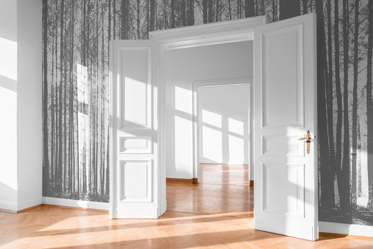 open room door in bright flat with photo wallpaper -