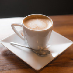 a white cup of coffee on the table