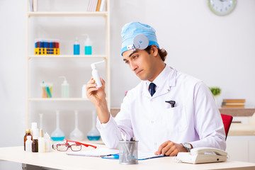 Young male doctor otolaryngologist working at the hospital 