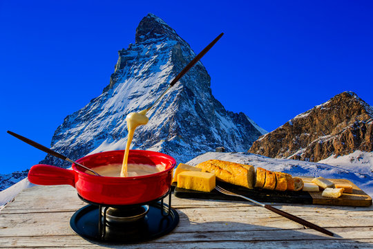 Fondue Cheese, Swiss Winter Ski Holidays Break For Lunch, Mountain View Matterhorn In Zermatt, Switzerland.