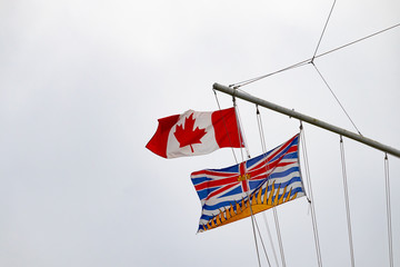 Canadian and British Columbian flags floating isolated