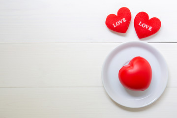 Red Heart with love and dish on wooden background, 14 February Valentine day, on grunge white wood, celebration and holiday concept, top view.