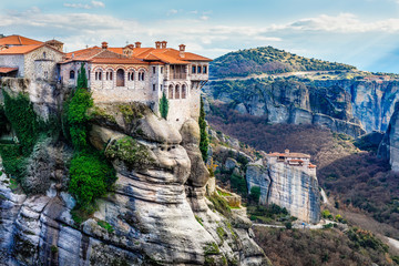 Fototapeta na wymiar Varlaam monastery located on the huge rock and Roussanou women Monastery below in the background, Kalabaka, Meteors, Trikala, Thessaly, Greece