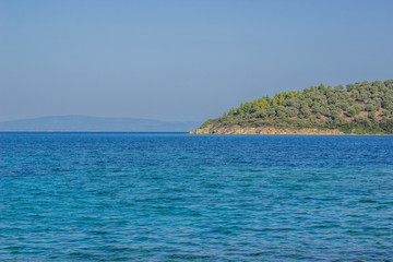 tropic Asian island scenic landscape background wallpaper concept with vivid blue water surface foreground, summer vacation or world travel photography concept, empty copy space for your text 