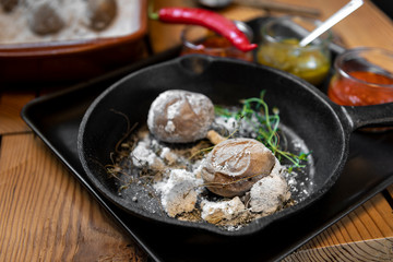 Baked potatoes in salt with hot salsa