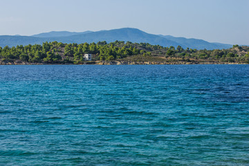 Asian tropic summer colorful landscape   with sea lagoon water surface foreground and island waterfront shoreline background 