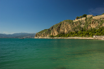 Fototapeta premium vivid colorful sea shoreline and mountain steep rock cape with castle on a top